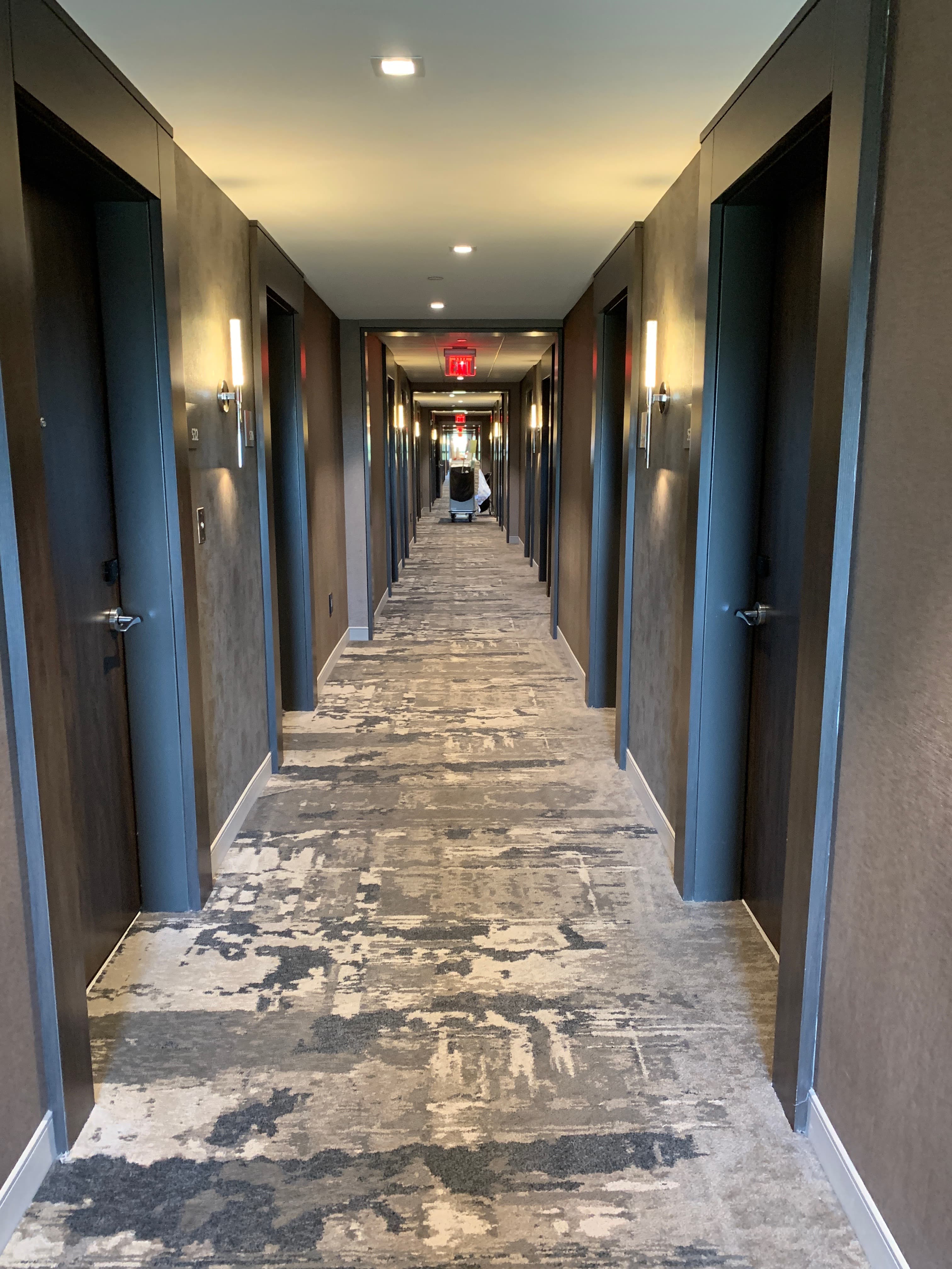 Truck-mounted commercial carpet cleaning in hotel hallway