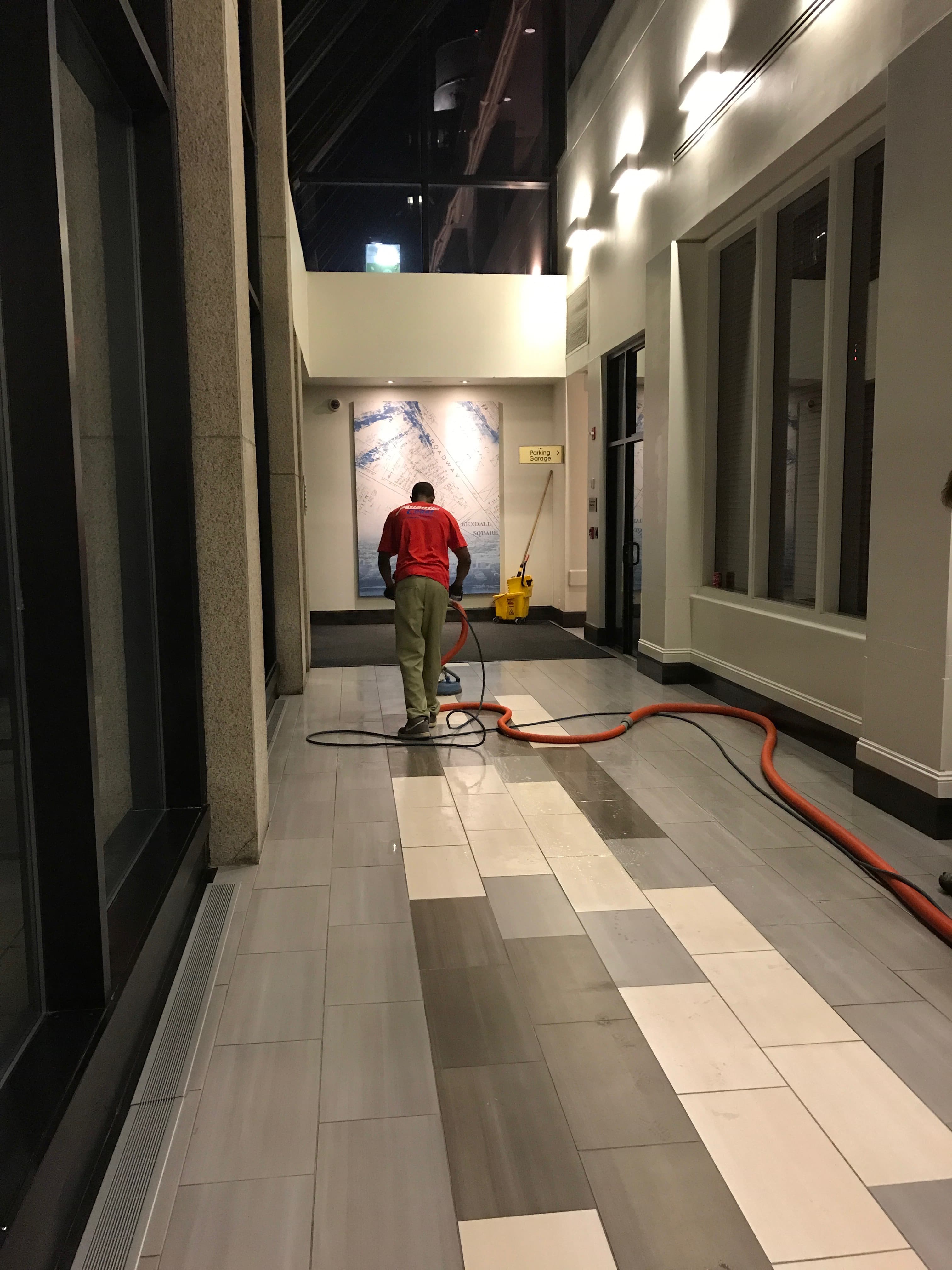 ACoast crew cleaning hotel lobby tile floor with professional equipment